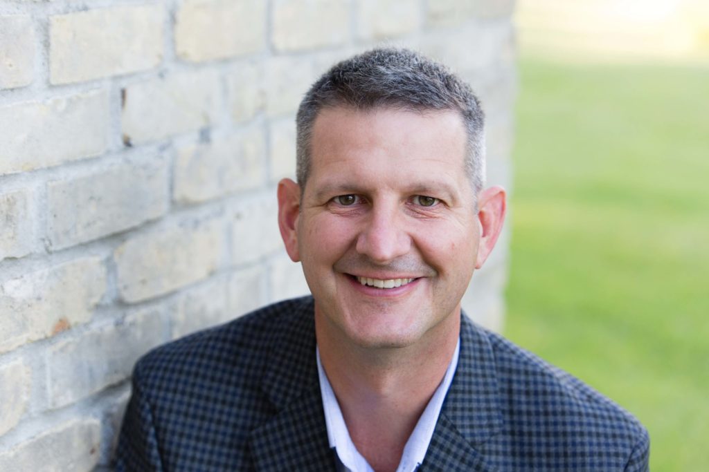 CJ Strehl smiling in a headshot phot