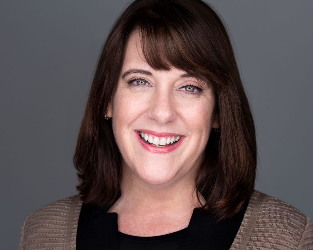 Lisa Toomey smiling in a headshot photo