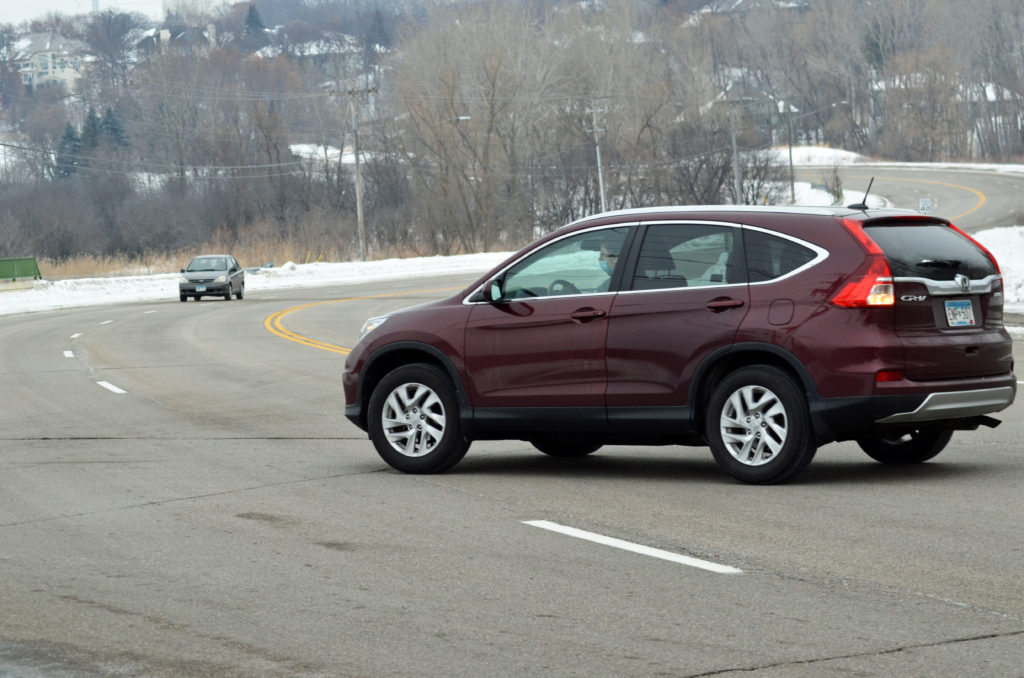 A motorist negotiated a left hand turn from Baker Road onto Holly Road. Under the county's proposal, a left hand turn lane would be added at the intersection. Photo credit- Jim Bayer