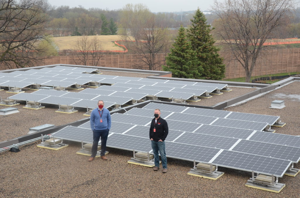 Jason Mutzenberger, left, and Kyle Fisher and the solar array on top of Eden Prairie Schools' Lower Campus.