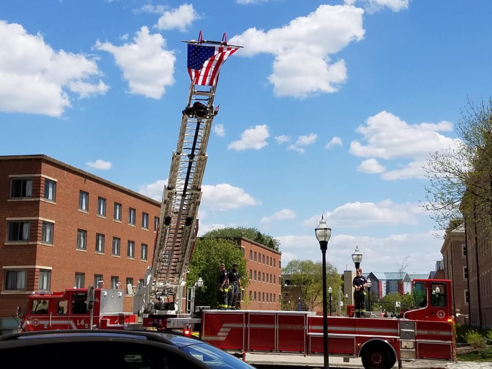 A Minneapolis ladder truck raises the flag outside the University of Minnesota Medical Center in honor of Spencer Conrad. PHOTO COURTESY OF THE CONRAD FAMILY