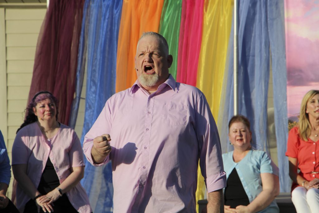 Scott Gorman singing "Lost in the Stars" from the musical of the same name with Penny Dale, Kelly O'Sullivan, and Ann Farrell in back. Photo courtesy Eden Prairie Players