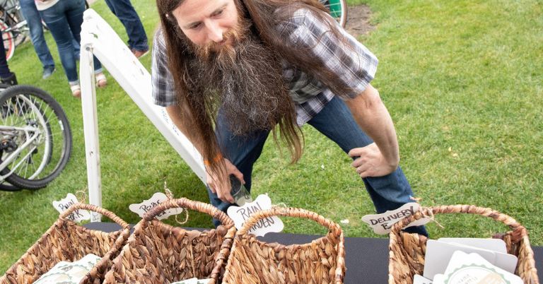 A man bending towards basket