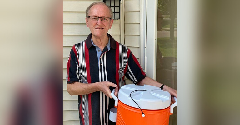 A picture of a man holding a cooler