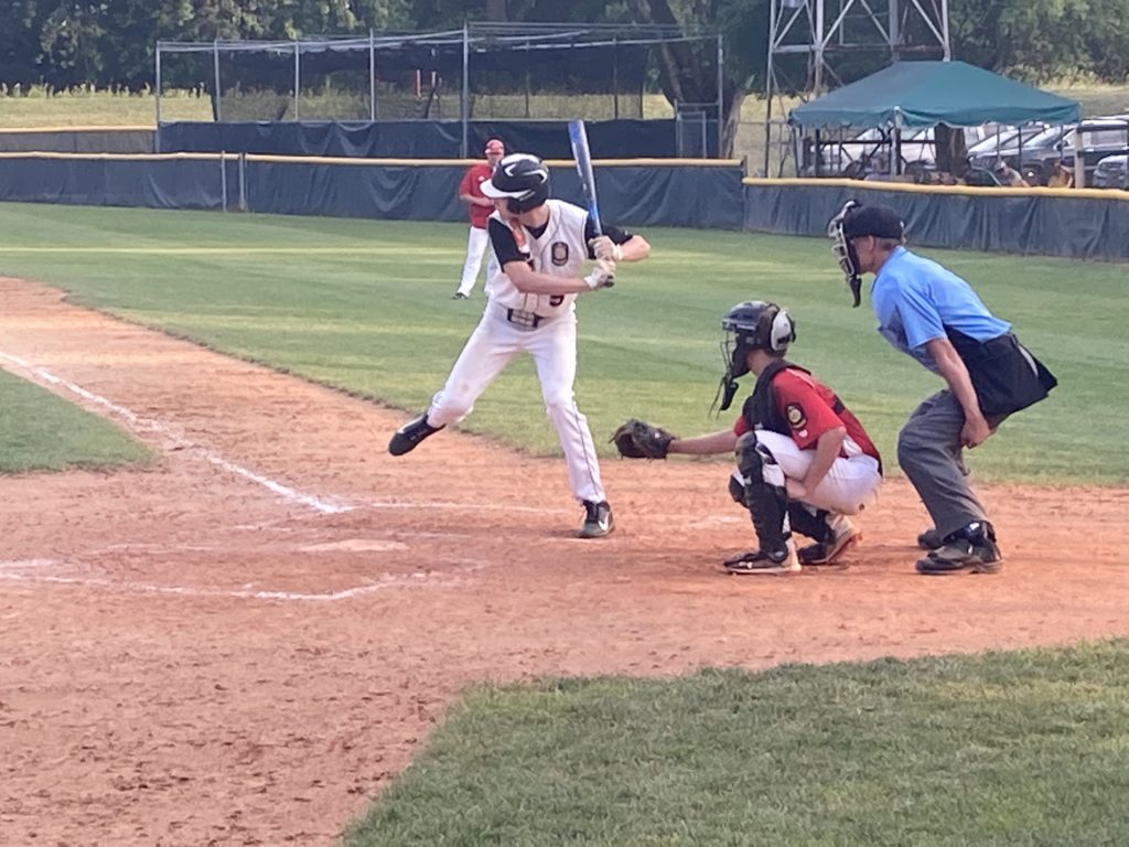 EP Legion Baseball players ready to hit and another in a ready to catch position