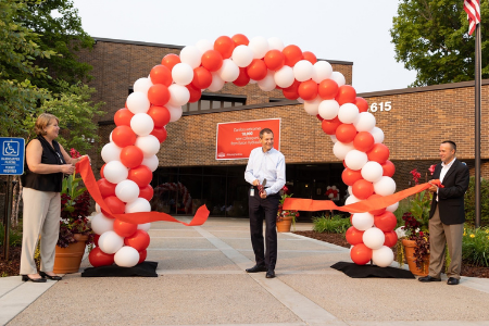 Executives Astrid Mozes, Kim Fausing, and Ryan Williams cut a ceremonial ribbon in Eden Prairie on Tuesday, Aug. 3 to mark the sale of Eaton Hydraulics to Danfoss A/S. (Eaton Corp. photo)