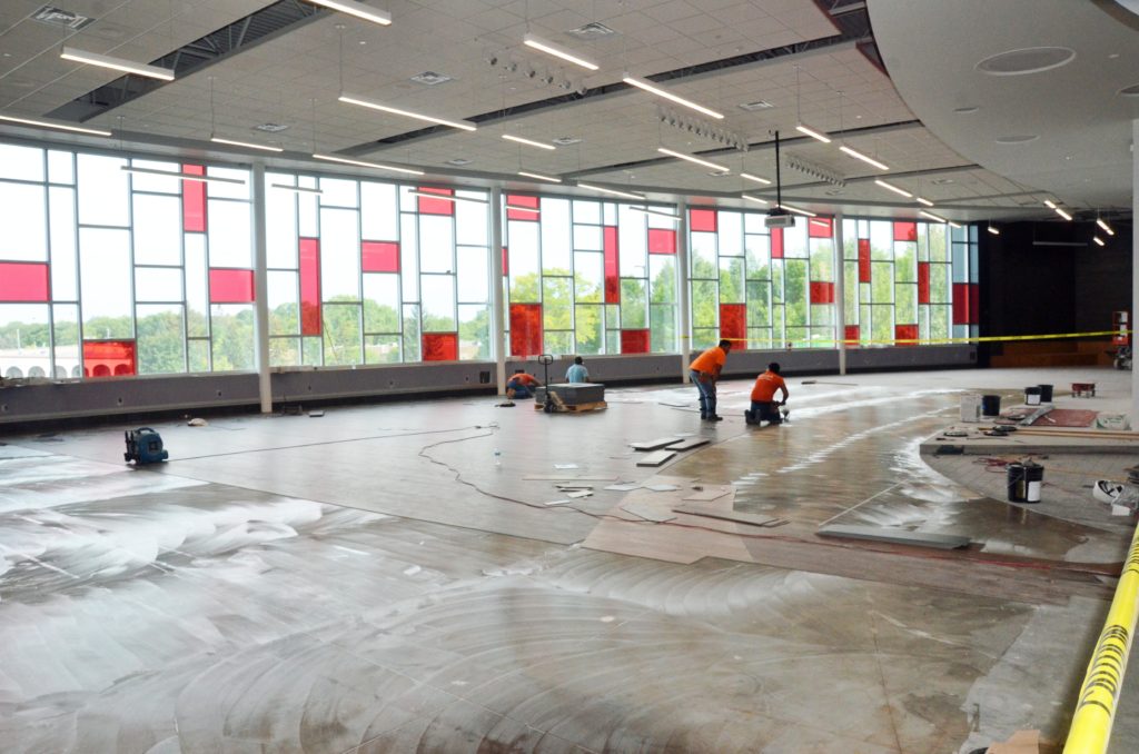 Photo of workers installing flooring in the new CMS cafeteria