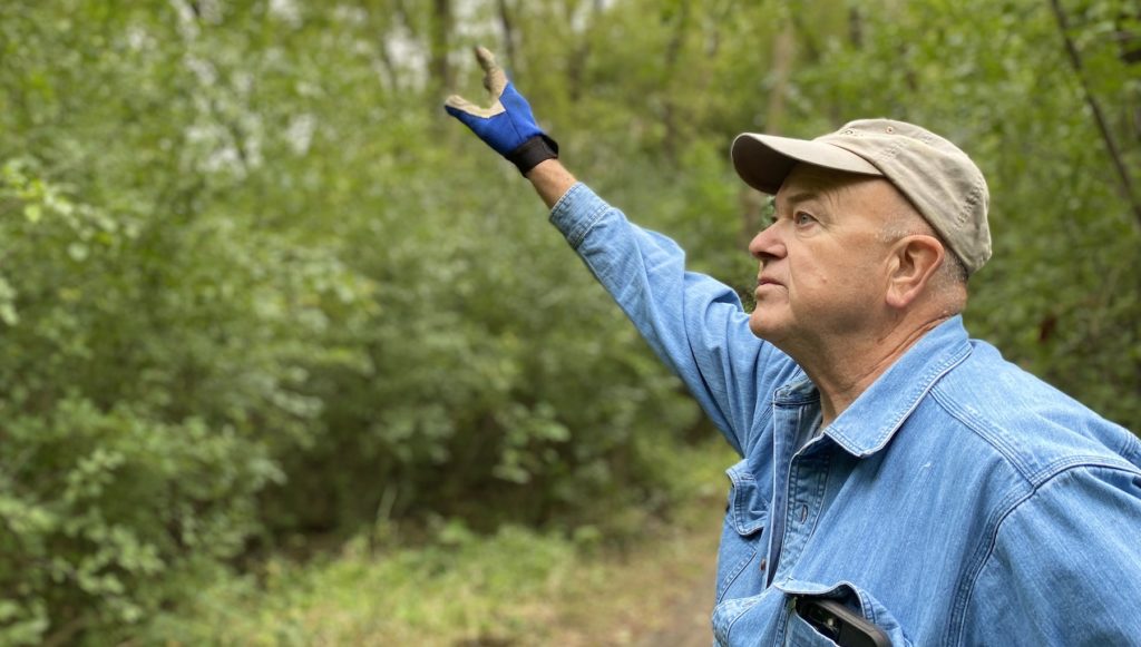 Glenn Olson motions upward as discusses the buckthorn problem in the Edenvale Conservation Area.