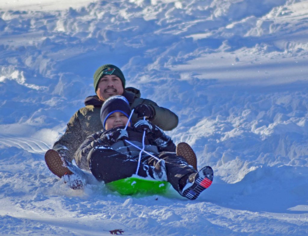 Carlos Gamarra and son Yago of Eden Prairie hit the slopes last year at Staring Lake sledding hill. File photo by Jim Bayer