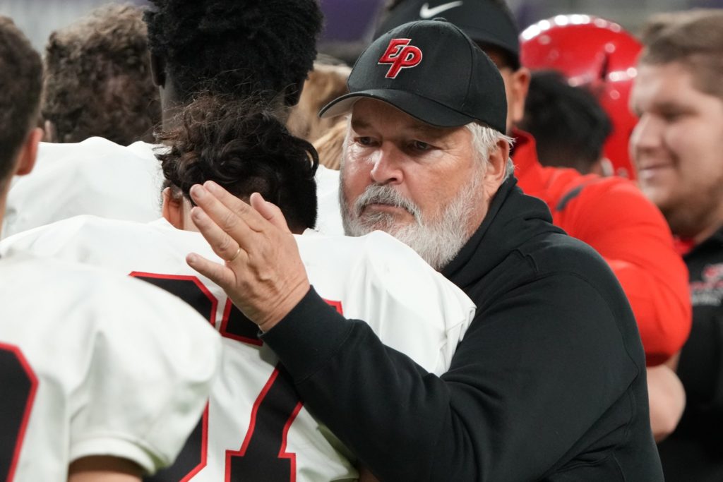 EP football coach Mike Grant consoles one of his players following the Eagles' season-ending loss to Maple Grove in the Class 6A state tournament. Photo by Rick Olson