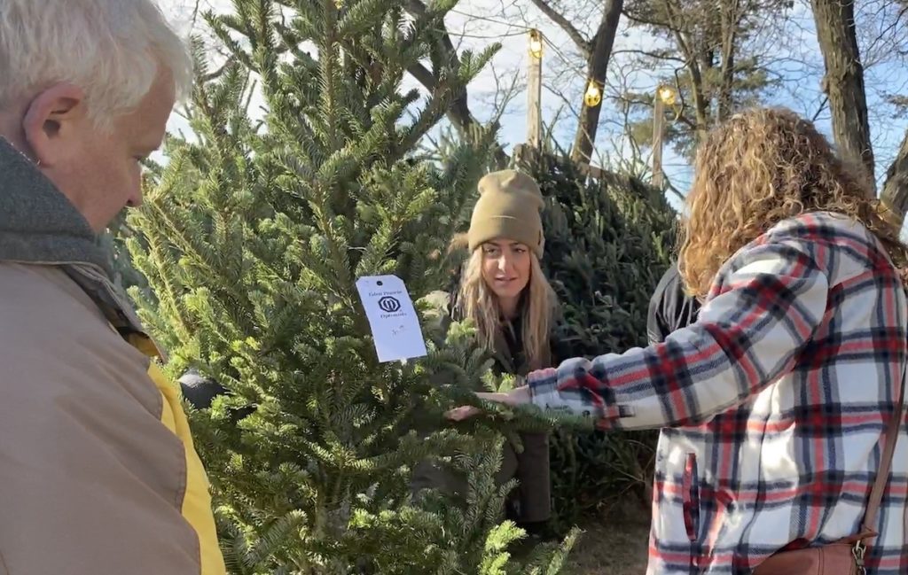 Sarah Murray (center) helps her mother Patti Fason find a tree at the Eden Prairie Optimist Club Tree Lot on Saturday, Nov. 27. Also pictured (left) is Optimist Club member Mark Weber. Photos by Stuart Sudak