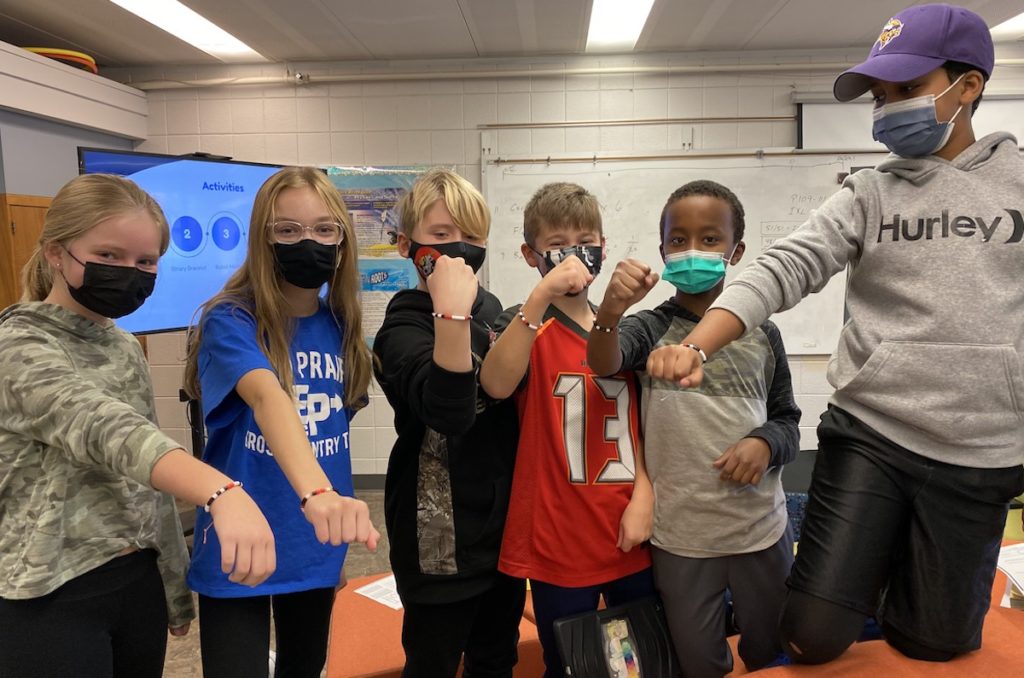 Prairie View fifth graders (from left) Kaitlyn Sporrong, Aubrey Managiello, Owen Stans, Will Lawinger, Ibrahim Omar, and Mohamed Noor show off their “Binary Bracelets.” Photos by Juliana Allen