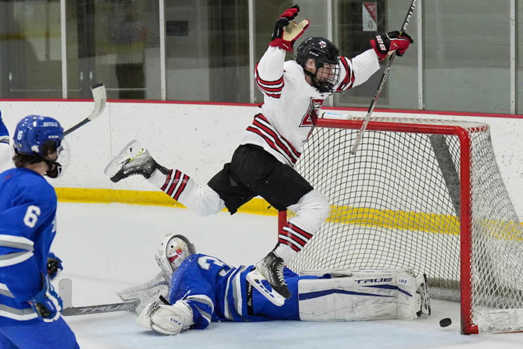 Eagles' forward Jake Luloff took off like an Eagle after scoring his third goal for a hat trick during a 9-0 win against Hopkins on Jan. 13. Luloff, a senior, is one of the team's captains. Photo by Rick Olson