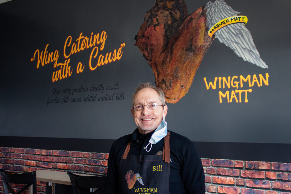 A picture of Bill Evanoff standing right in front of Wingman Matt.