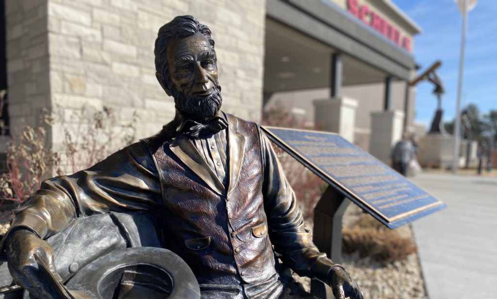 The Abraham Lincoln statue sitting in front of the Eden Prairie Scheels basks in the sunshine on Sunday. Though Presidents Day on Monday, Feb. 21, is a federal holiday, this Lincoln (along with nearby statues of Washington and Reagan) will remain on the job greeting customers. Photo by Stuart Sudak