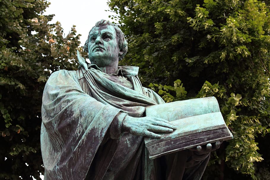 A statue of Martin Luther holding a Bible in Berlin.