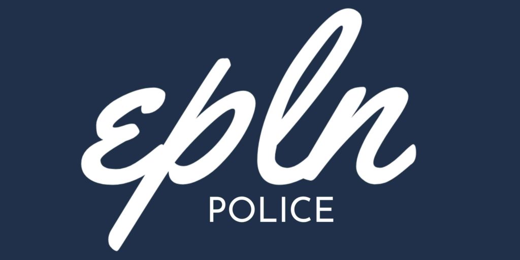 Bill Hammes of the Minnesota Office of Traffic Safety presents Eden Prairie Police Officer Chad Streiff with a hockey stick recognizing his three DWI arrests during a Sept. 5–6 shift. Photo courtesy of the City of Eden Prairie