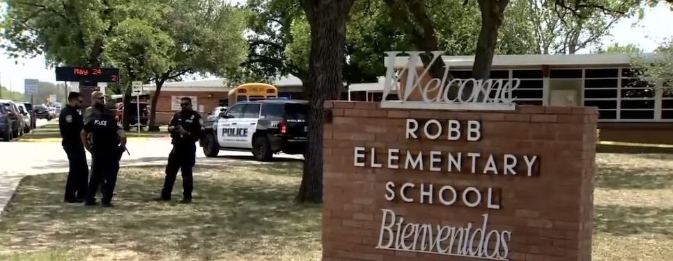Police stand outside the Robb Elementary School in Uvalde, Texas, where 19 children and two adults were killed on Tuesday. 
