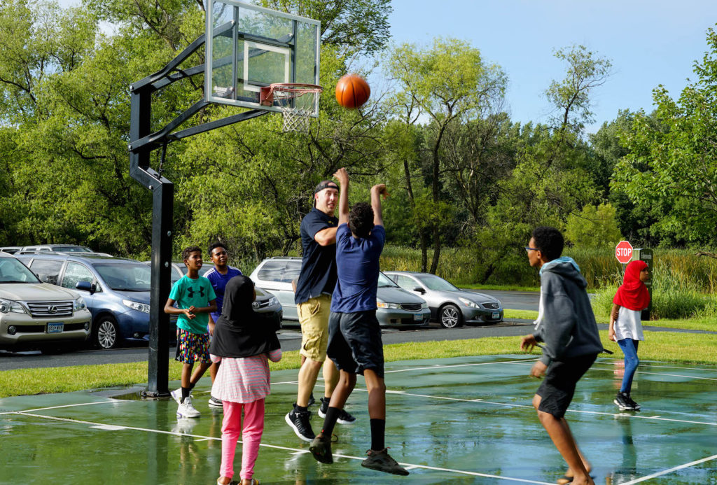 Eden Prairie Police Sgt. Cory Sinon plays basketball with kids during a past Edenvale Park Kickin' with the Cops event. Photos courtesy of the City of Eden Prairie