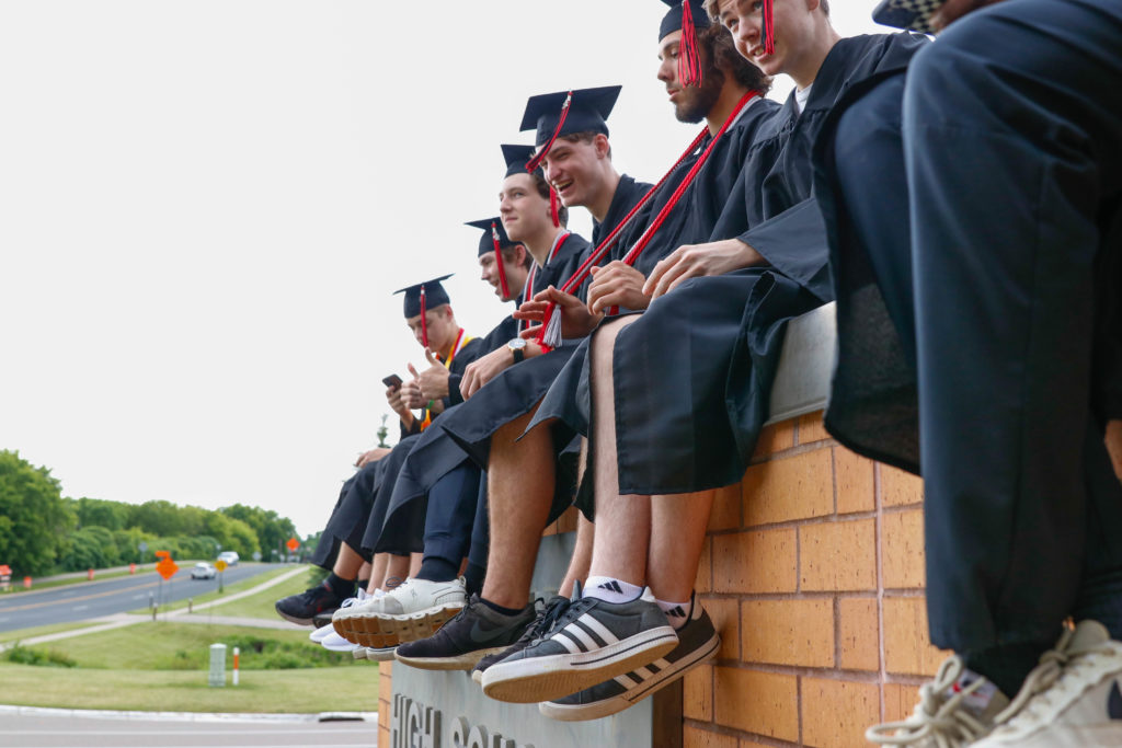 The 2022 graduates take photos and celebrate at the high school before the graduation ceremony.