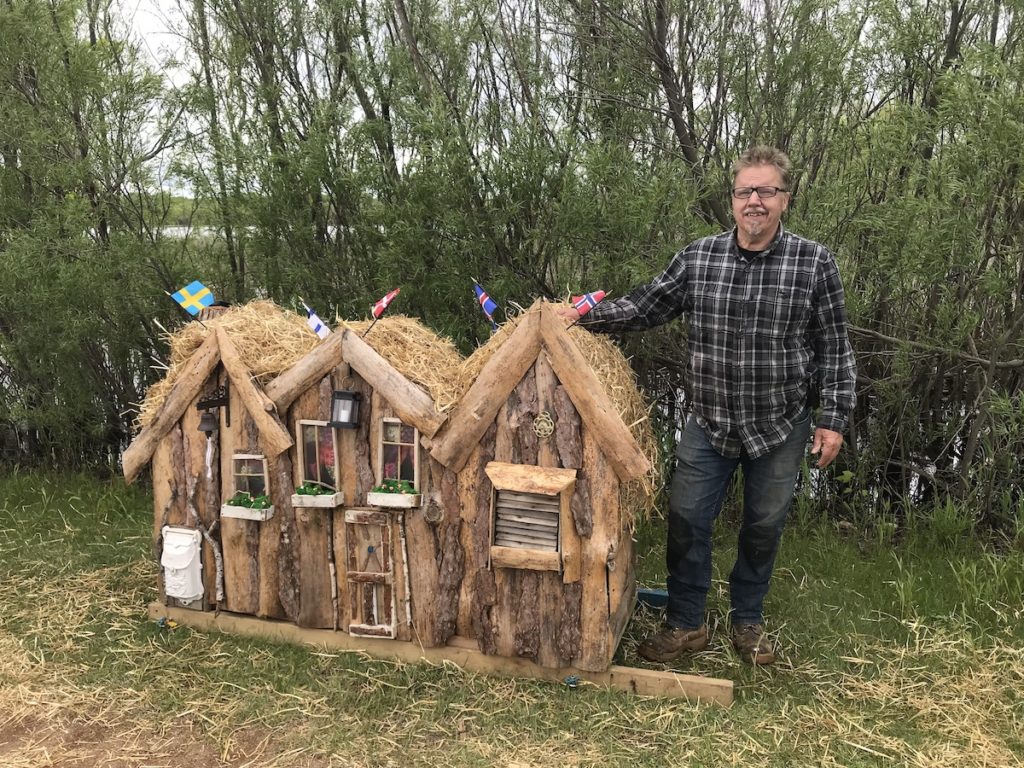 Artist Jerry Carlson poses with the traditional Icelandic-style elf house he recently installed at Purgatory Creek Park. Photo courtesy of Jerry Carlson