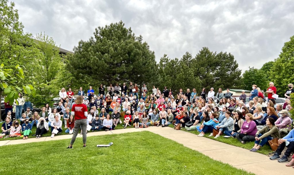 The west metro Moms Demand Action group gathers on the lawn outside the Edina Library to meet and discuss strategies for moving forward. Submitted photo
