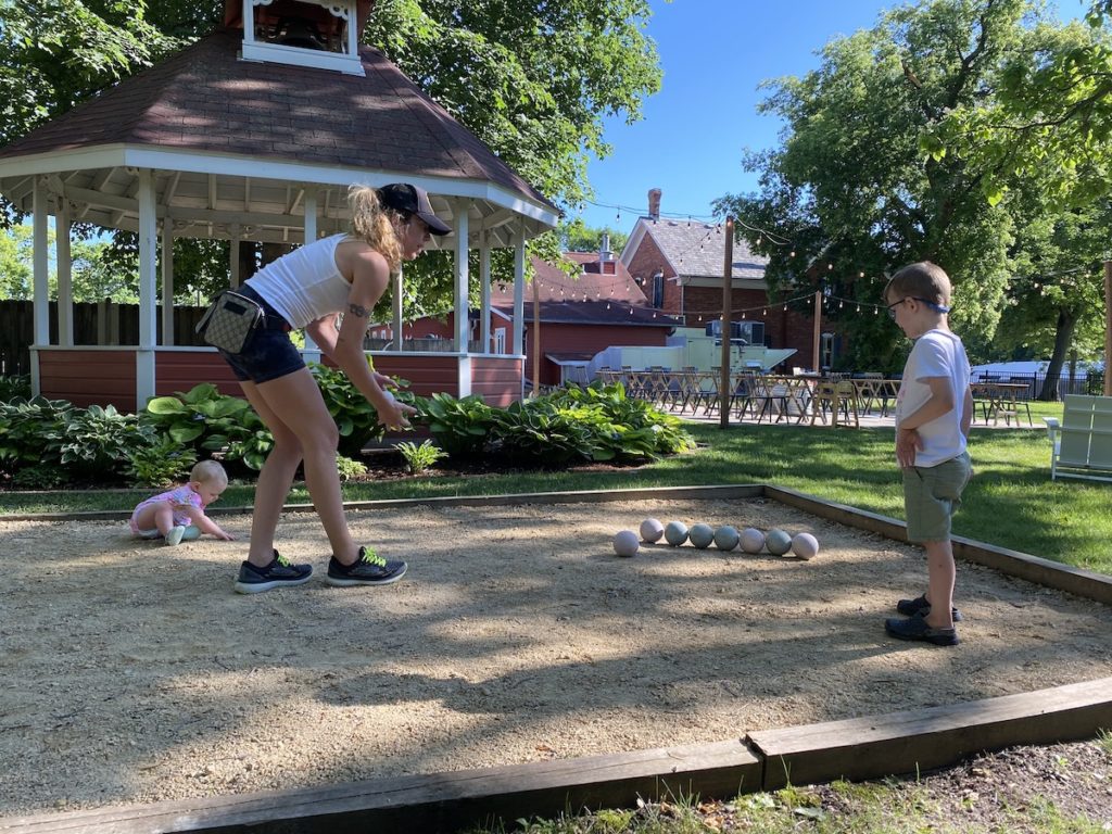 Goldie Graham and her children play a game of bocce ball while waiting for their pizza order at Smith Coffee & Cafe in Eden Prairie. Photo by Juliana Allen