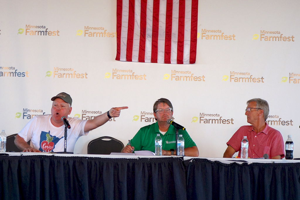 Gov. Tim Walz and Republican candidate Scott Jensen shown during Wednesday's forum at Farmfest. Moderator Blois Olson is in the middle. MinnPost photos by Peter Callaghan