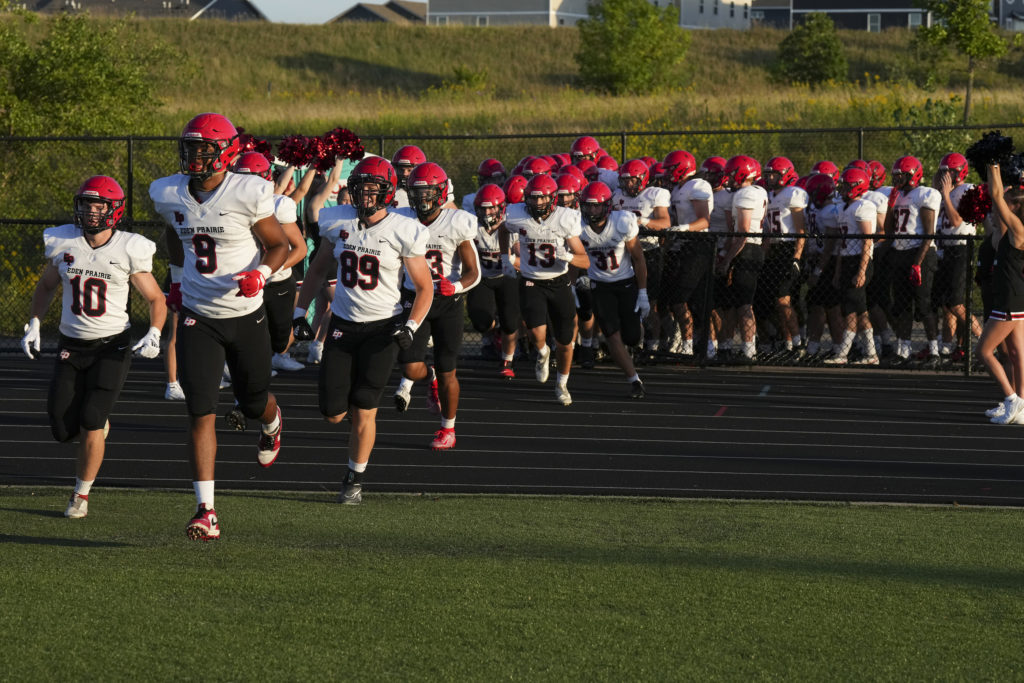 The Eden Prairie Eagles take the field for their season opener against East Ridge. Photo by Rick Olson