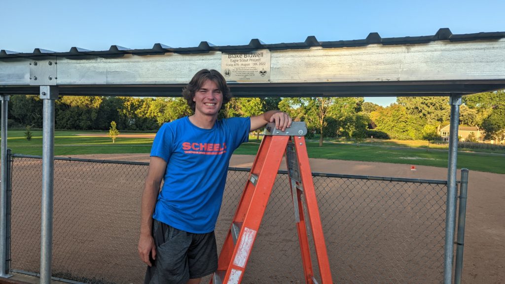 Blake Bidwell installed the plaque on the completed dugout shelters on Aug. 31. Photos courtesy of the Bidwell family