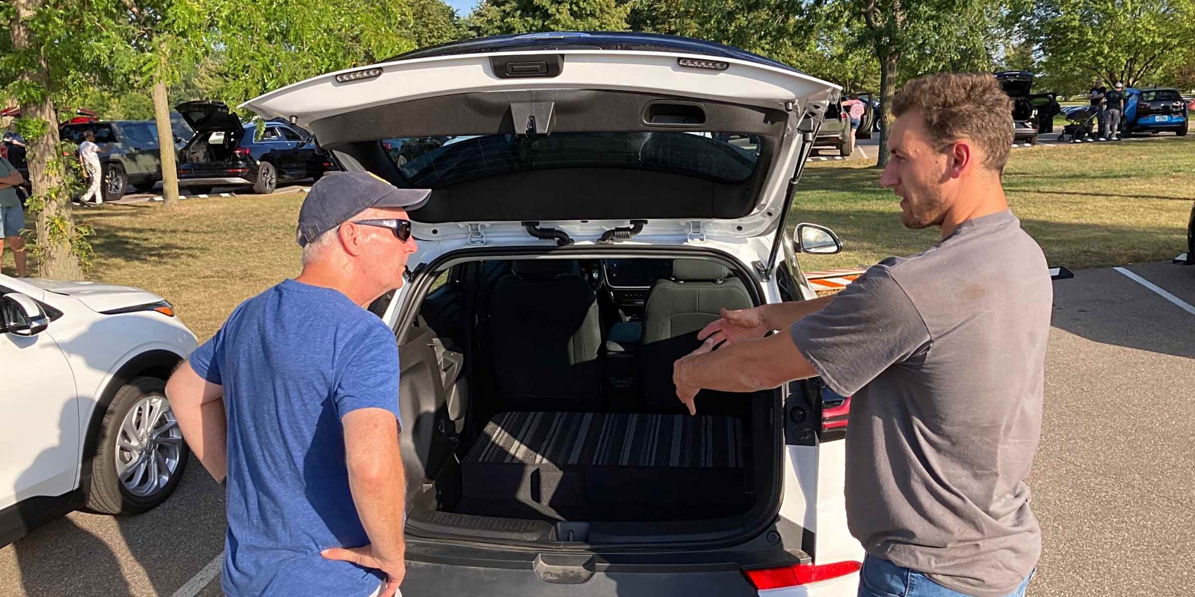 Denny Christianson (left) gets a firsthand look at electrical vehicles, with help from City of Eden Prairie employee Steve Matula, at the Sept. 19 Electric Vehicle Ride and Drive Event held at Staring Lake Park. Photo by Mark A. Weber