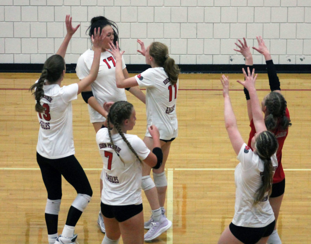 The EP volleyball team celebrates a point during Thursday's match against Edina via a block. Photo by Ryan Williamson.
