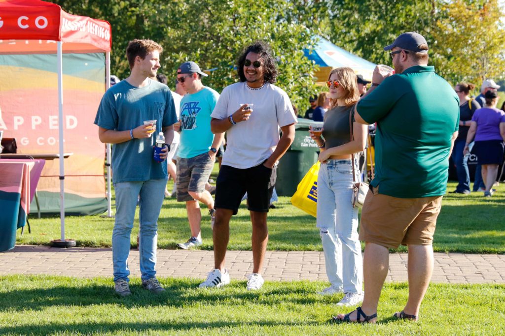 Attendees enjoy some craft brews and conversation at last year's Prairie Brewfest in Purgatory Creek Park. File photo by Gillian Holte