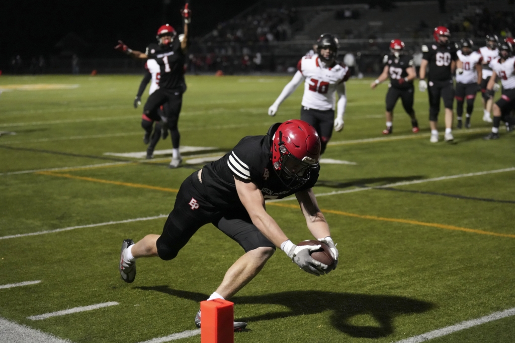 Senior Adam Mertens (7) dives for a touchdown in the second quarter vs. Shakopee. Photo by Rick Olson