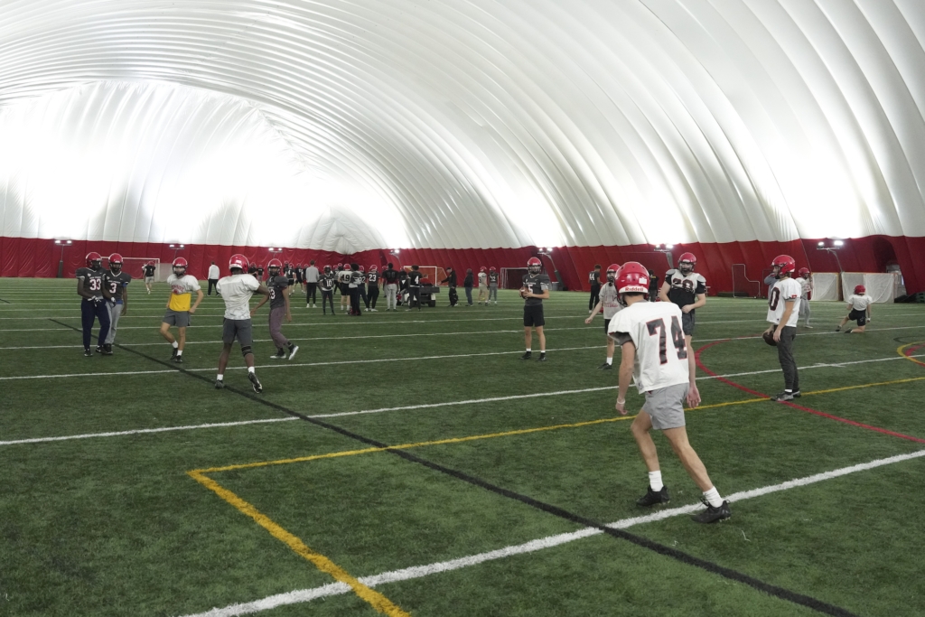 The Eden Prairie Eagles prepare for the state semifinal game inside the practice dome at EPHS on Tuesday. Photo by Rick Olson