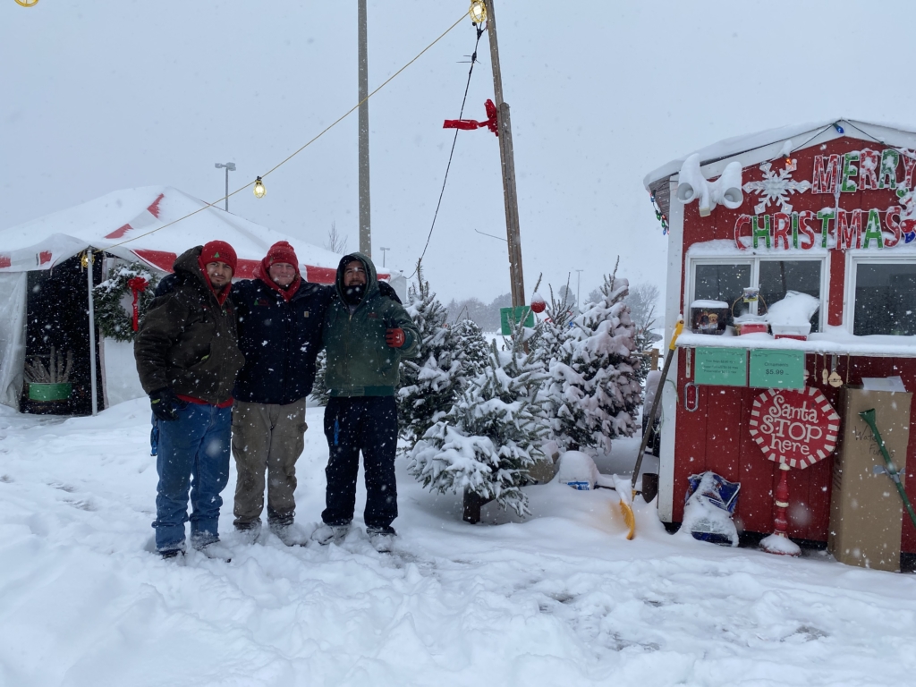 Austin Graber and his colleagues Victor and Aaron are ready to help you find a Christmas tree. Photos by Juliana Allen