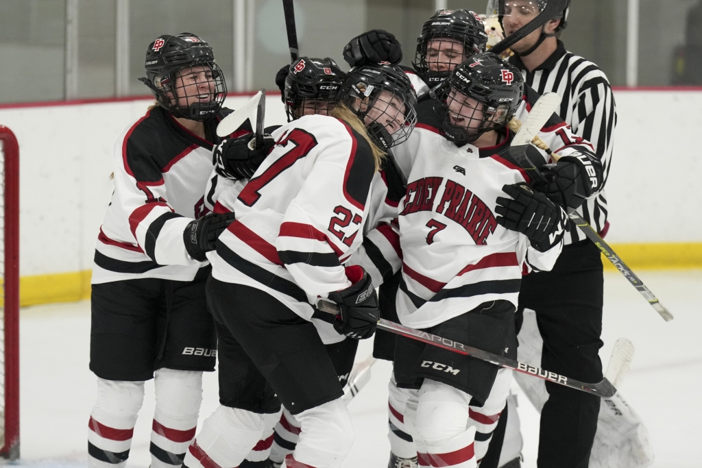 The Eagles celebrate freshman Sara David’s (27) goal in the second period Thursday vs. Maple Grove. Photo by Rick Olson