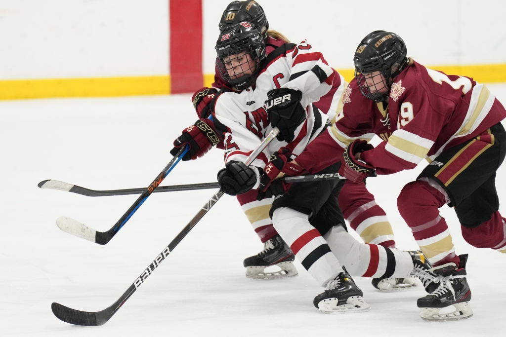Eagles senior forward Jordan Hirsch breaks through opposing defenders near the blue line Thursday night vs. Maple Grove. Photo by Rick Olson