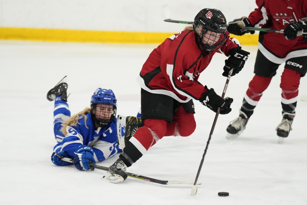 Eagles defender Ella Konrad (7) picked up a loose puck in the third period Tuesday against Minnetonka. Photo by Rick Olson