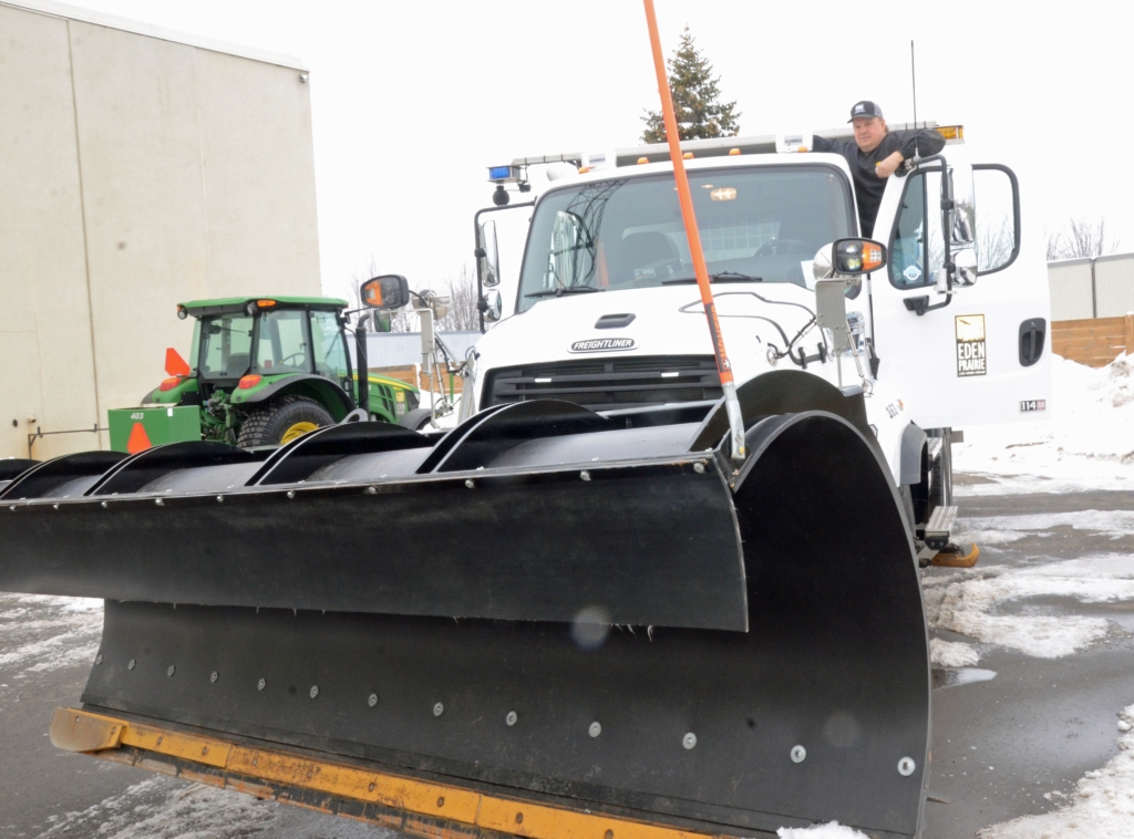 Eden Prairie streets maintenance worker Mike Schmidt atop his snow plow. Photos by Jim Bayer