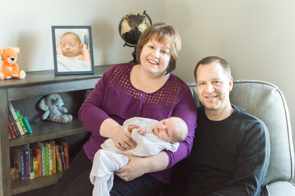Gregg and Jana posed for a photo shortly after adopting their son, with a picture of the baby they had originally planned to adopt in the background. That baby, a boy, died of a medical condition in 2016 before they could complete the adoption process. Photos courtesy of the family
