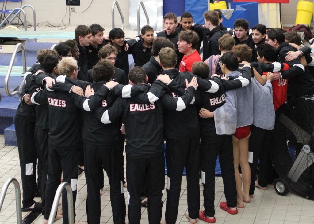 Lillejord (center, in red shirt) leading a team cheer before the meet. Photo by John Folks