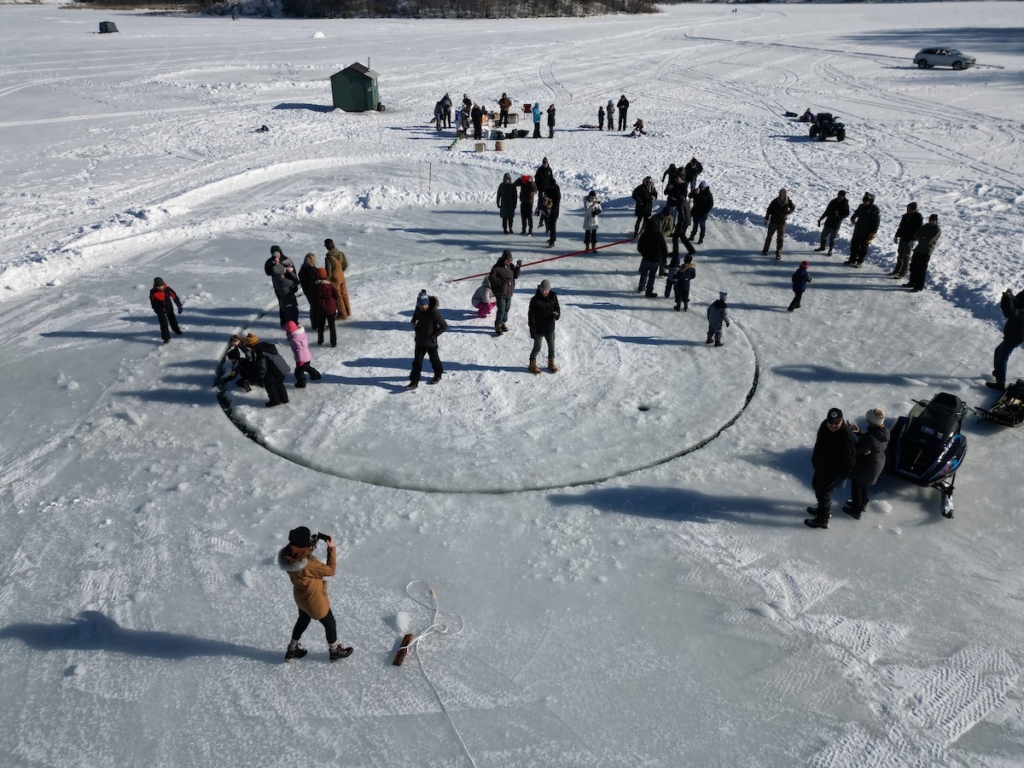 Riding the 32-foot diameter, 60,000-pound ice carousel at Red Rock Lake proves to be a winter adventure for these thrill-seekers. Photos by Kelley Regan