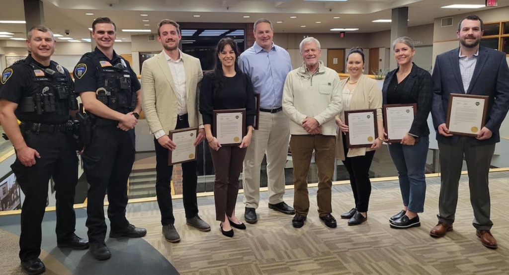 From left: EP police officers Thor Carlson and Eric Bromback, who responded to the scene, Nate Storey, Jill Bickler, Matt Johnson, Peter Graff, Alisa Hoang, Marie Goergen, and Doug Tucker. Photo courtesy of the City of Eden Prairie