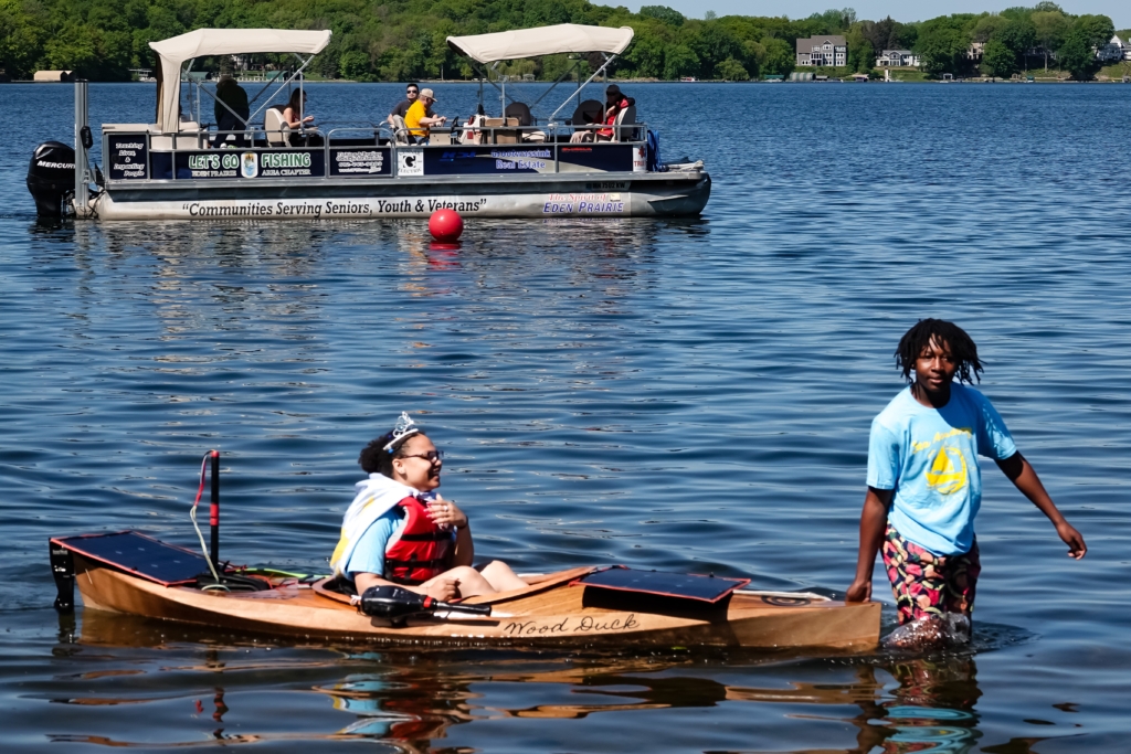 Contestants from Sea Academy at City Academy High School in the water with their solar boat. Photo by Gretchen Haynes