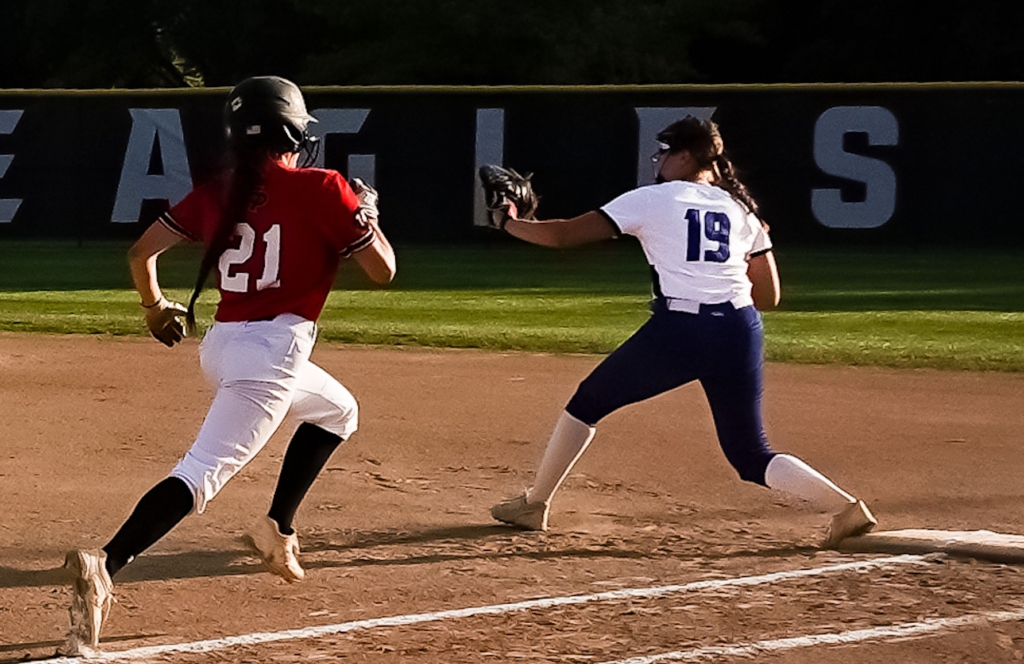 Eden Prairie sophomore Lily Liu hustles to beat out a single as Minnetonka's Ava Klick reaches for the throw. The Eagle defeated the Skippers on May 25 and have now advanced to the Section 2AAAA tournament finals. Photo by Gretchen Haynes
