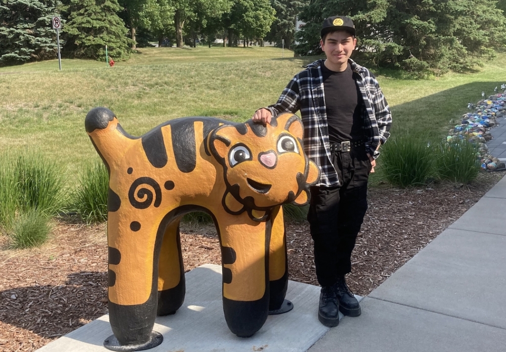 Artist Michael Finch stands beside his sculpture Guardian 2, on display outside the Eden Prairie Art Center as part of the city's Rotating Art Series.