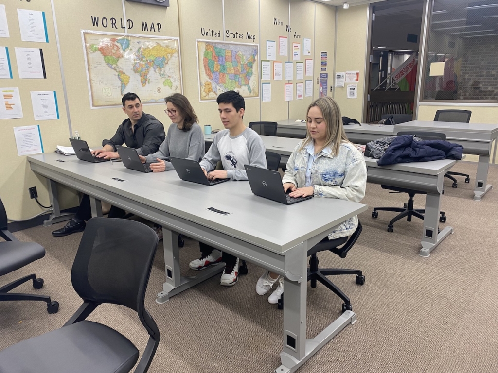 English learners from Venezuela, Ukraine, Mexico, and Colombia assist each other with a writing assignment in English. Photos courtesy of the Metro South Adult Basic Education