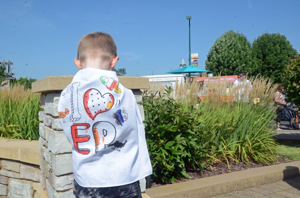 Malcolm Dobson sported a a cape declaring his love of Eden Prairie. Art in the Park 8-19-23