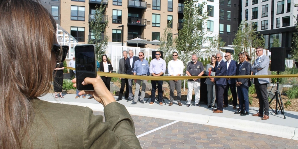 All cameras turned to a ribbon cutting that was part of a ceremonial grand opening of Paravel Apartments in Eden Prairie on Aug. 17. Paravel, developed by Timberland Partners, is part of a wave of apartment construction in the city. Photo by Mark Weber